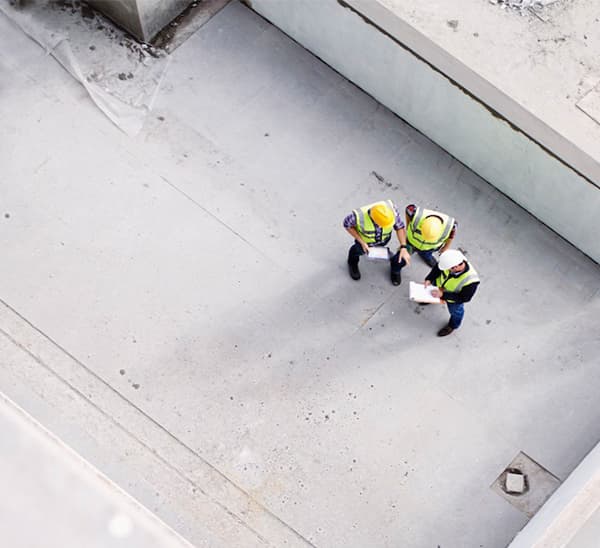 Aerial view of developers in discussion on the progress of a new build.